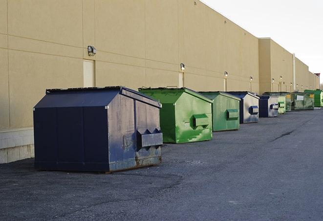 a crowd of dumpsters of all colors and sizes at a construction site in Diamond Point, NY